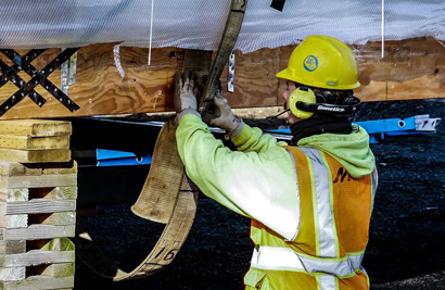 Construction crew member fastening strap.