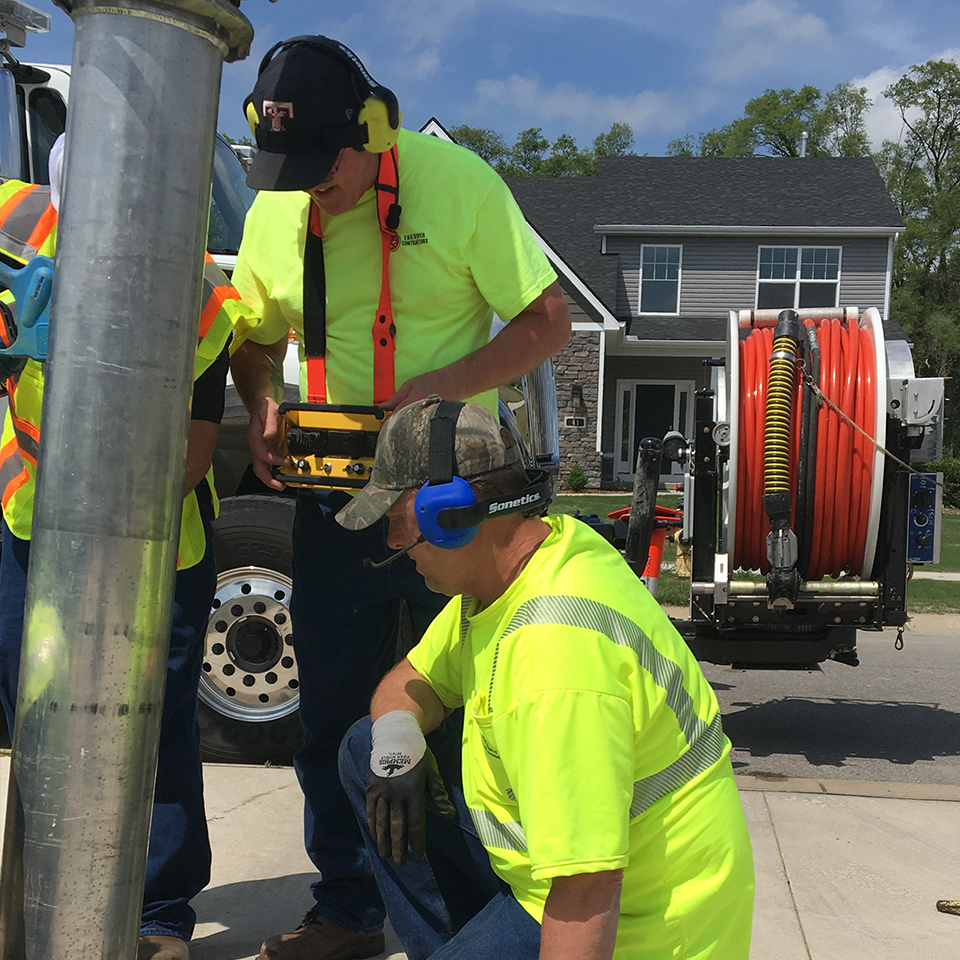 Sewer clean-out crew using Sonetics Portable Wireless System.