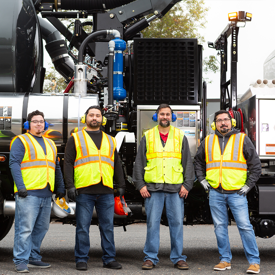 Public Works crew using Sonetics Portable Wireless System in front of vacuum truck.