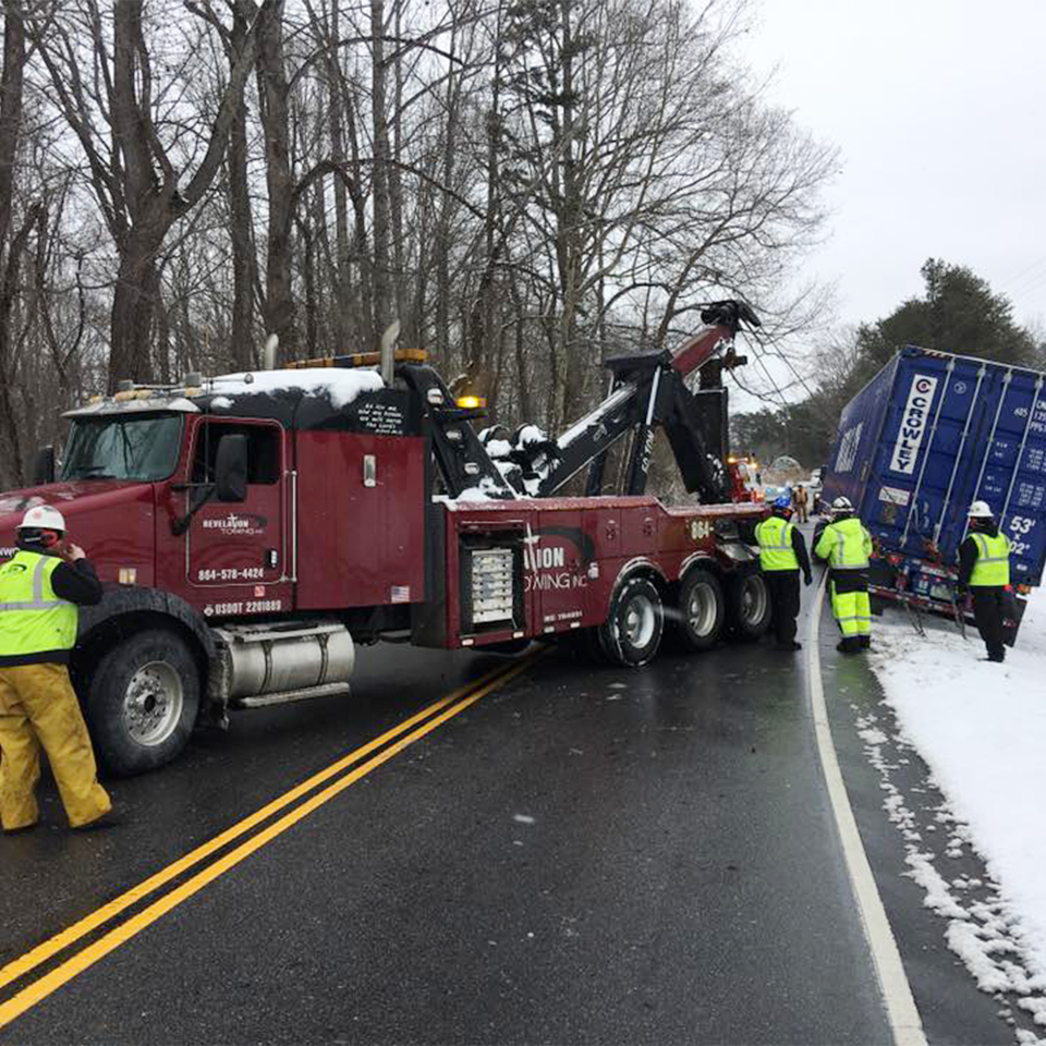 Towing and recovery crew working in snow.