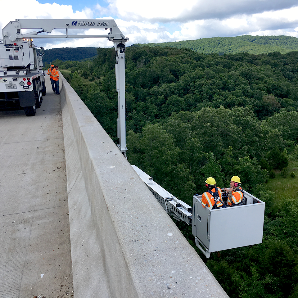 Snooper truck crew inspects bridge.