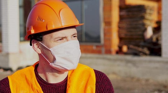 Construction worker wearing N95 mask on the jobsite.