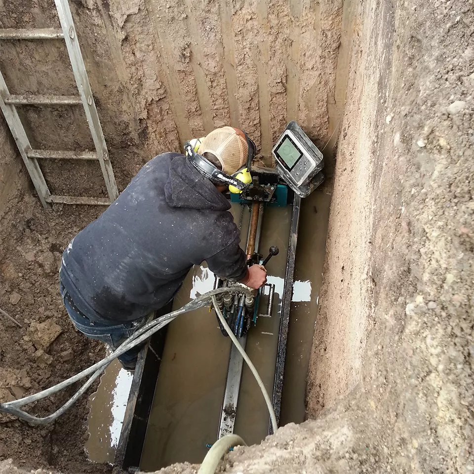 Directional drilling crew repairing burst pipe.